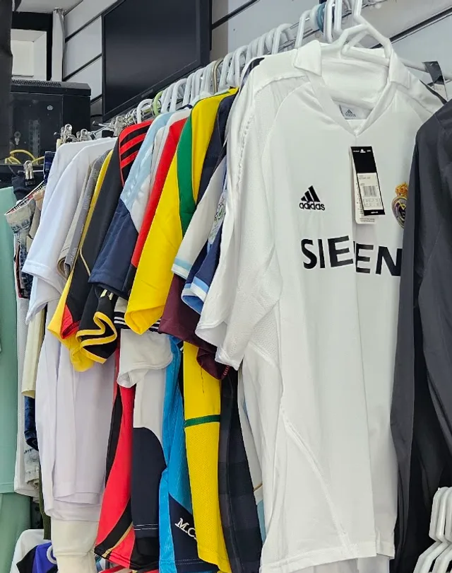 Football jerseys hanging on the rail inside the shop